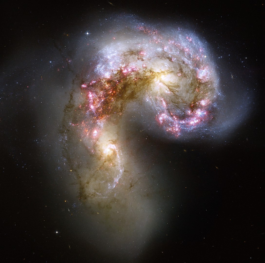 Imagem das galáxias Antena, uma galáxia starburst cheia de regiões H II e que vive uma explosão de novas estrelas devido à colisão entre NGC 4038 e NGC 4039.